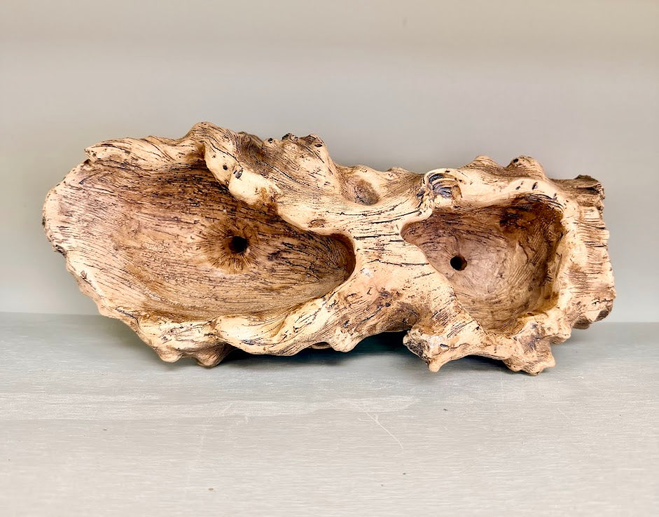 Top-down view of two planting openings in resin driftwood log planter