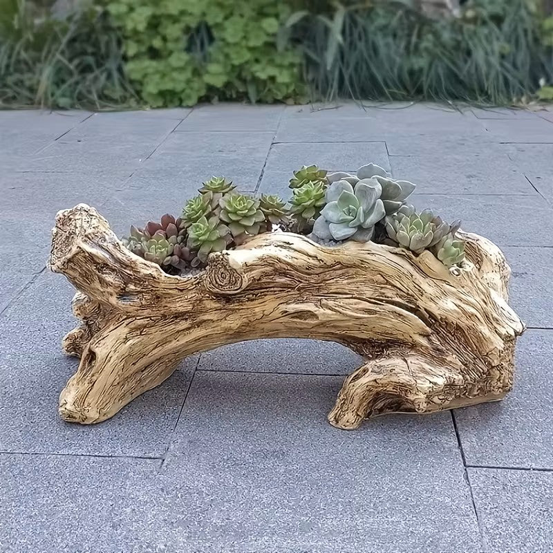 Wooden log planter with succulents on a stone pavement