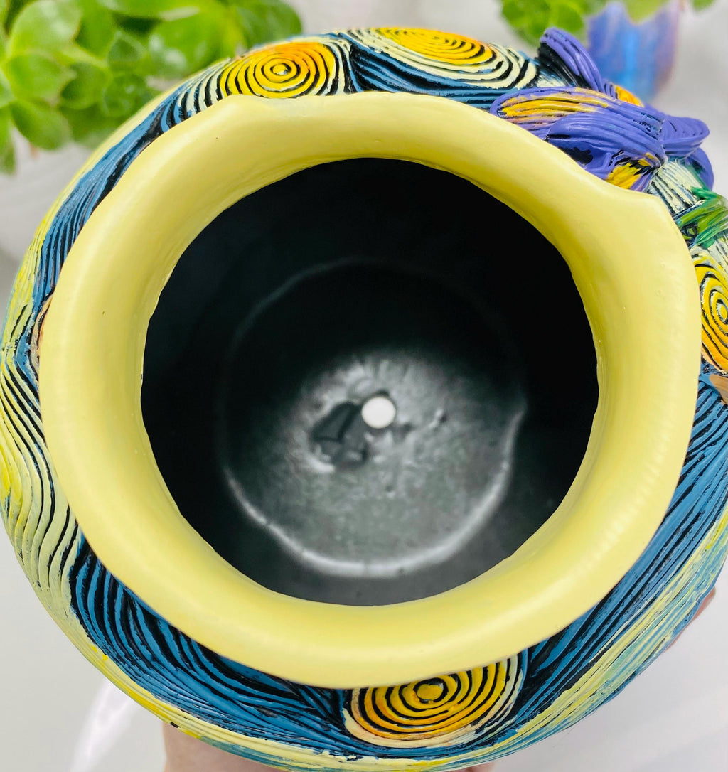 Close-up of built-in drainage hole in colorful Starry Night–inspired art planter for succulents and decorative plants
