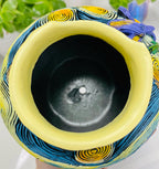 Close-up of built-in drainage hole in colorful Starry Night–inspired art planter for succulents and decorative plants